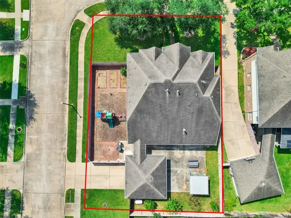 an aerial view of a house with a garden and plants