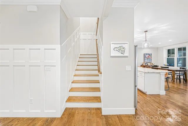 a view of a kitchen with furniture and wooden floor