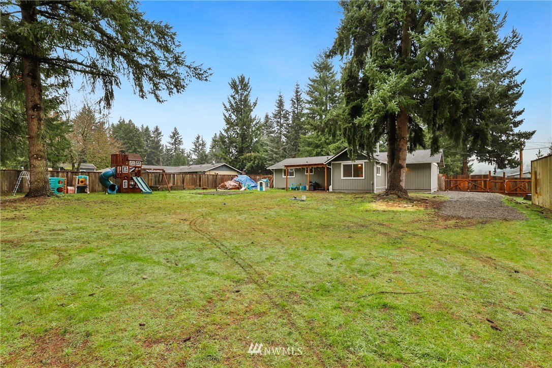 18625 Nutmeg Street Southwest Rochester, WA 98579 - Photo 17 of 18 a view of a house with a yard and sitting area