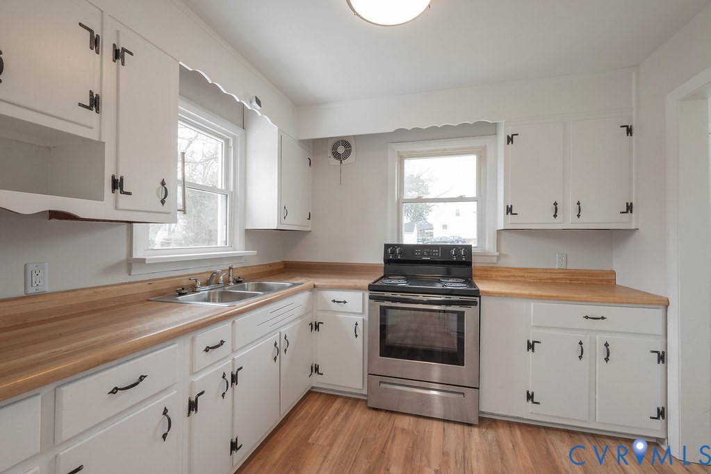 1715 West City Point Road Hopewell, VA 23860 - Photo 13 of 22 a kitchen with granite countertop white cabinets and white appliances
