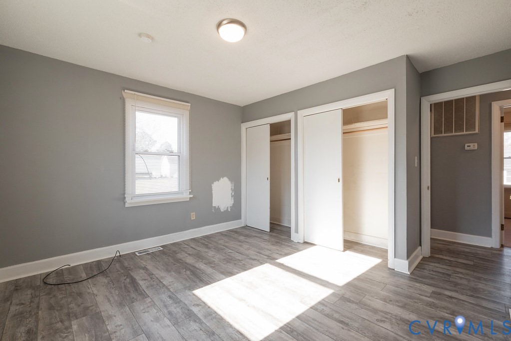 1715 West City Point Road Hopewell, VA 23860 - Photo 13 of 30 an empty room with wooden floor and windows