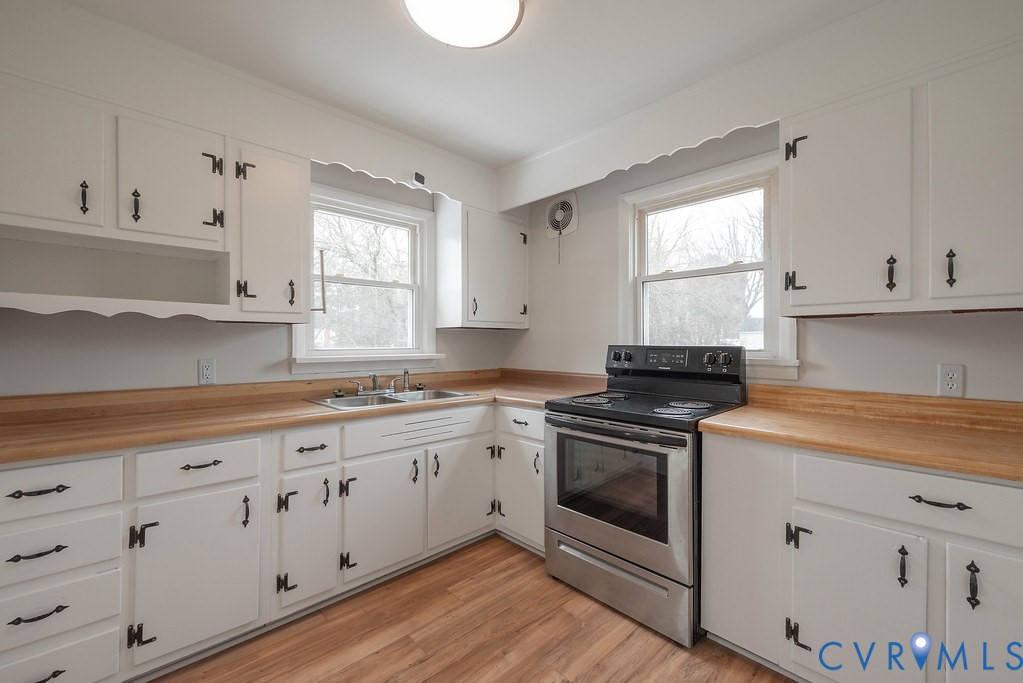 1715 West City Point Road Hopewell, VA 23860 - Photo 14 of 22 a kitchen with cabinets appliances a sink and a window