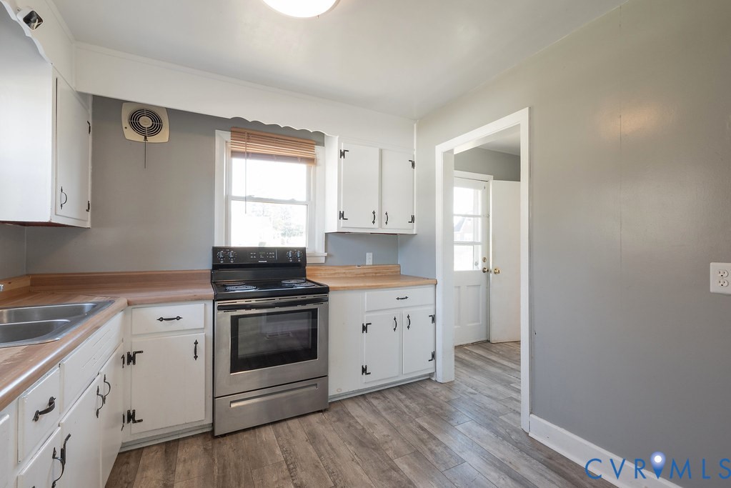 1715 West City Point Road Hopewell, VA 23860 - Photo 16 of 30 a kitchen with cabinets appliances and wooden floor