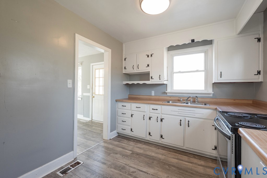 1715 West City Point Road Hopewell, VA 23860 - Photo 17 of 30 a kitchen with granite countertop white cabinets and white appliances