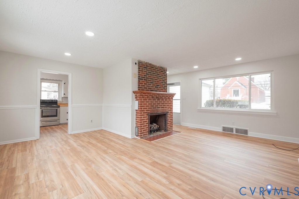 1715 West City Point Road Hopewell, VA 23860 - Photo 5 of 22 a view of an empty room with wooden floor and a window