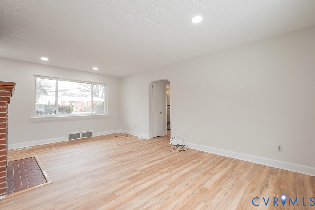 1715 West City Point Road Hopewell, VA 23860 - Photo 6 of 22 an empty room with wooden floor and windows