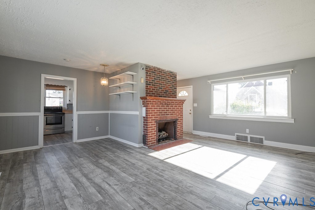 1715 West City Point Road Hopewell, VA 23860 - Photo 7 of 30 an empty room with windows and fireplace