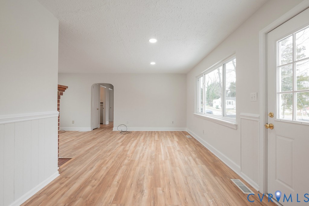 1715 West City Point Road Hopewell, VA 23860 - Photo 7 of 22 an empty room with wooden floor and windows