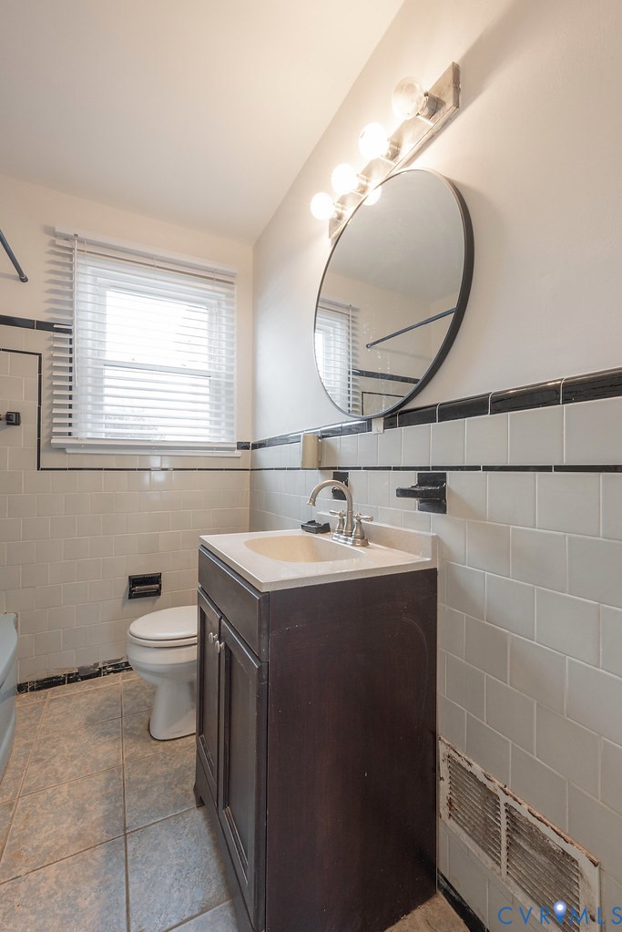 1715 West City Point Road Hopewell, VA 23860 - Photo 8 of 22 a bathroom with a sink a toilet and a mirror