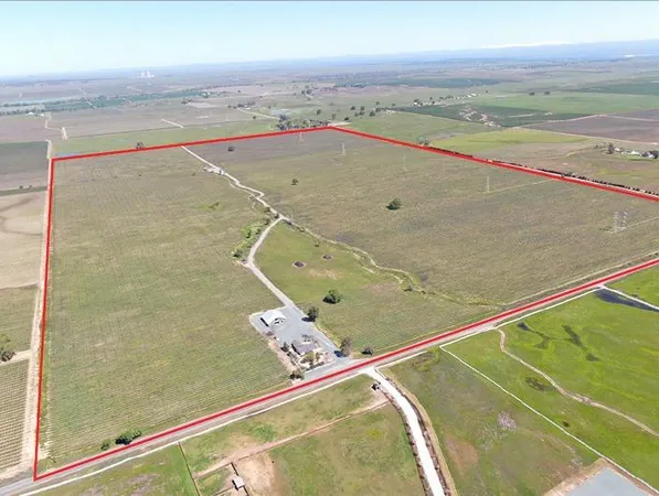 a big house with a big yard and large trees