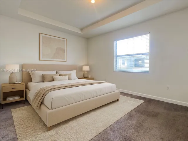 a bedroom with bed and window