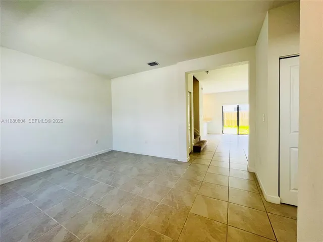 a view of a hallway with wooden shelves