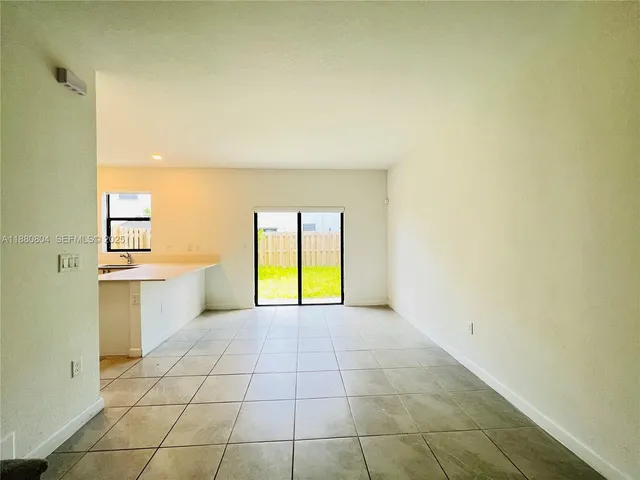 a view of a kitchen with a sink and a window