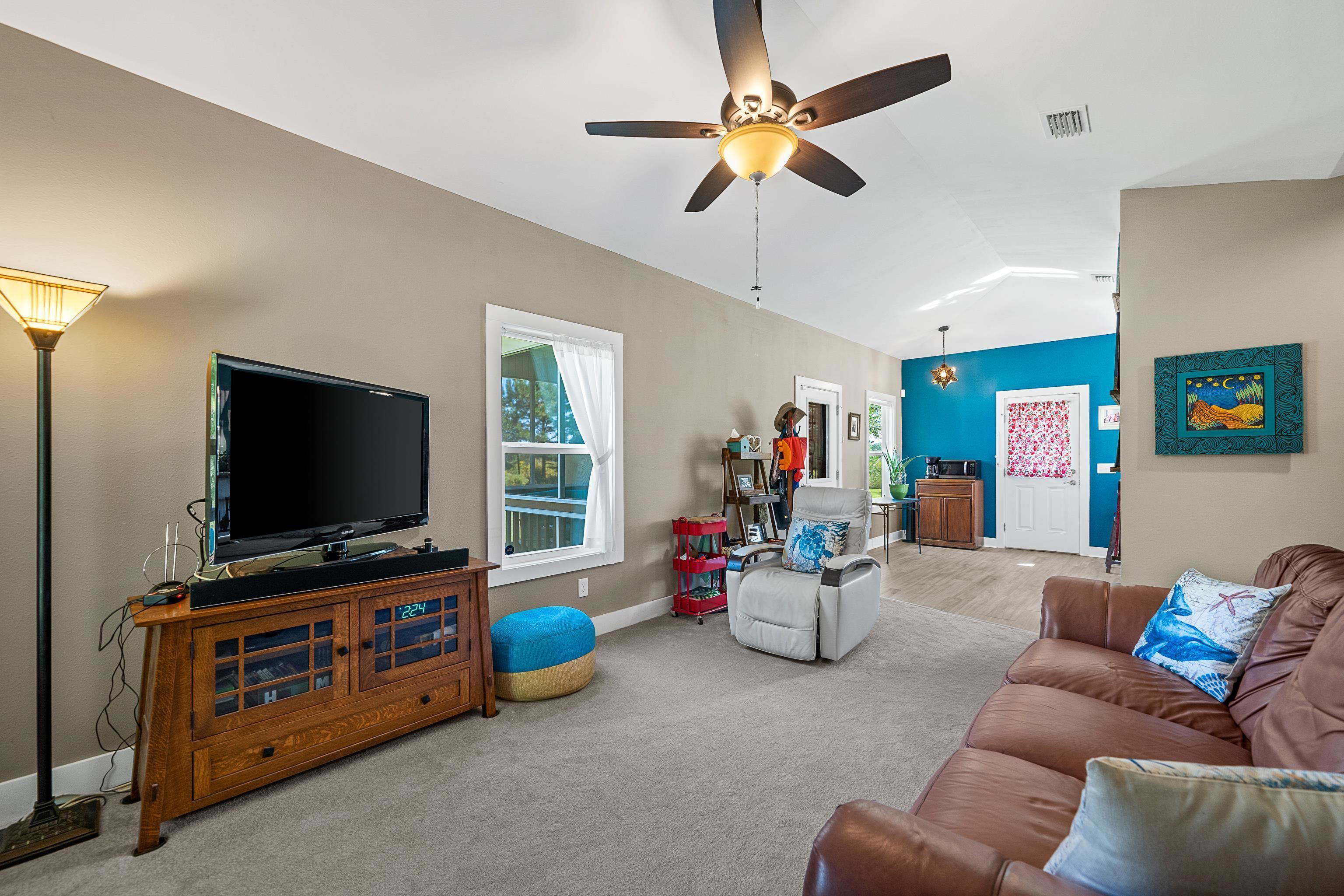24616 Bretz Lane Elberta, AL 36530 - Photo 15 of 42 Vaulted living room flowing seamlessly into dining area.