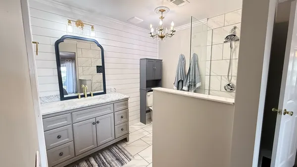 a bathroom with a double vanity sink mirror and