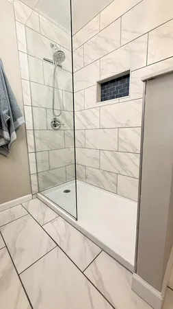 a bathroom with a shower and a glass door