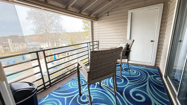 a view of a hallway with furniture and a window