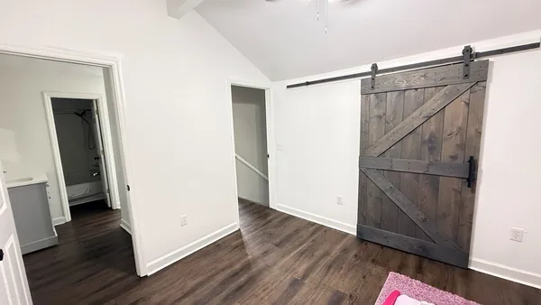 a view of walk in closet with wooden floor