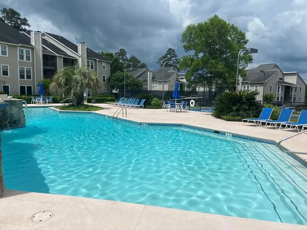 a swimming pool with outdoor seating and yard