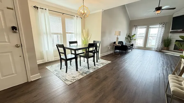 a view of a livingroom with furniture and a window