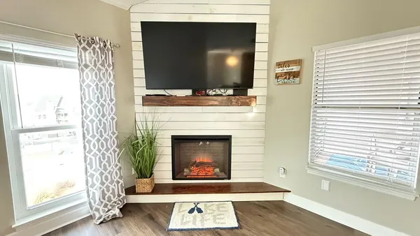 a living room with a fireplace and a flat screen tv