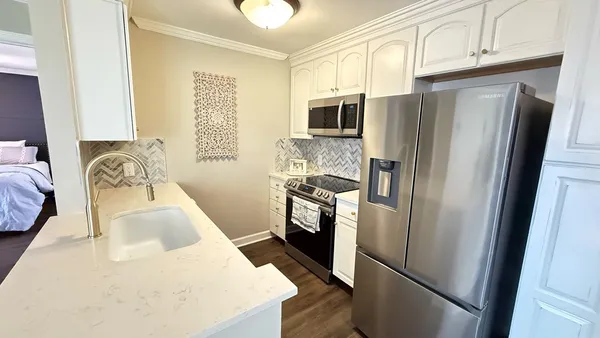 a kitchen with stainless steel appliances a refrigerator sink and stove