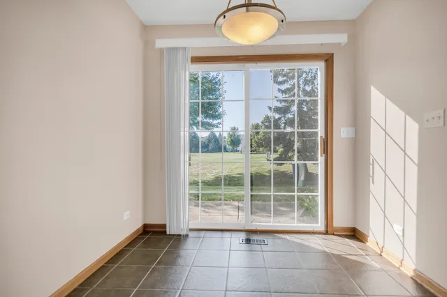 a view of a big room with wooden floor and windows