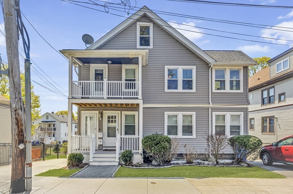 9-11 Locust Street, Unit 2 Winthrop, MA 02152 - Photo 1 of 41 a front view of a house with a yard