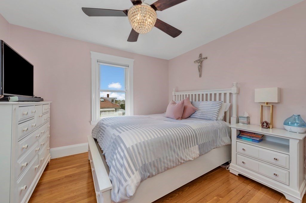 9-11 Locust Street, Unit 2 Winthrop, MA 02152 - Photo 19 of 41 a bedroom with a bed and a flat tv screen on dresser