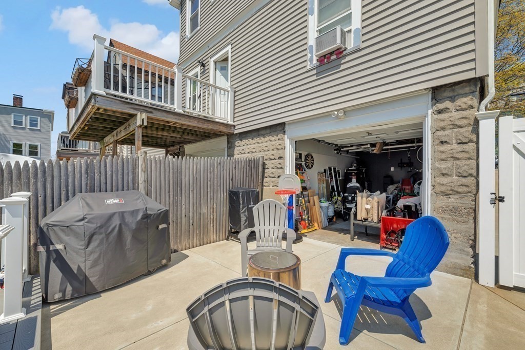 9-11 Locust Street, Unit 2 Winthrop, MA 02152 - Photo 29 of 41 a view of a patio with table and chairs