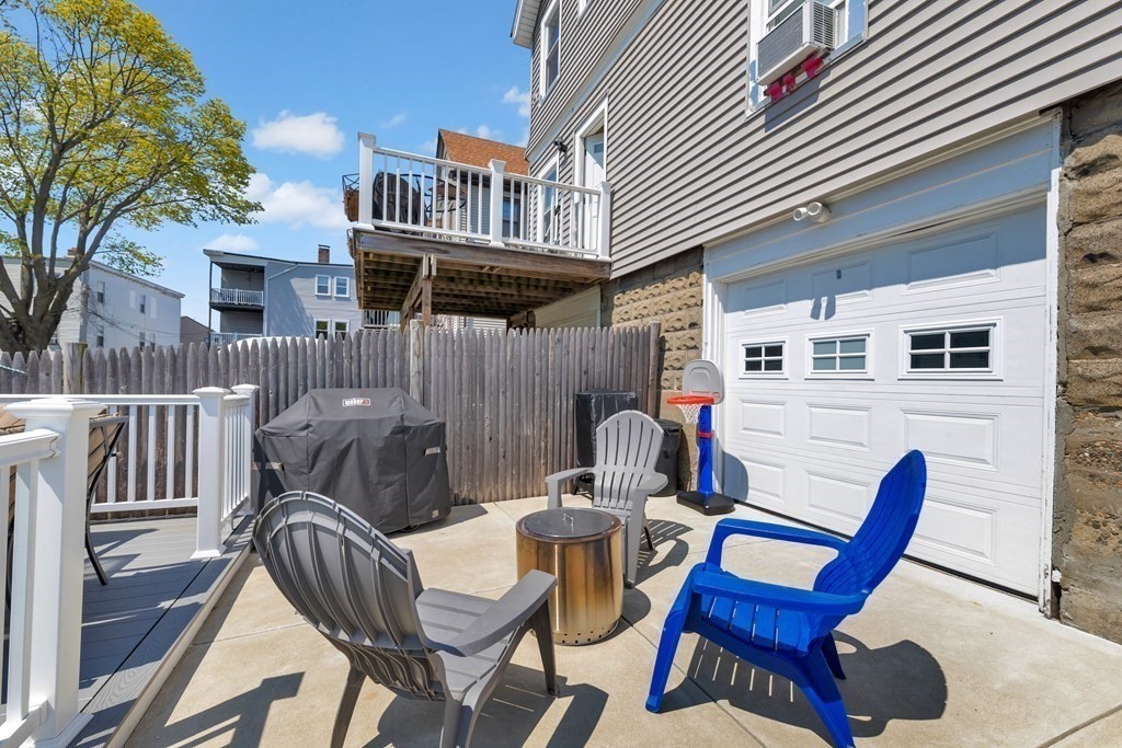 9-11 Locust Street, Unit 2 Winthrop, MA 02152 - Photo 33 of 41 a view of a patio with a table and chairs