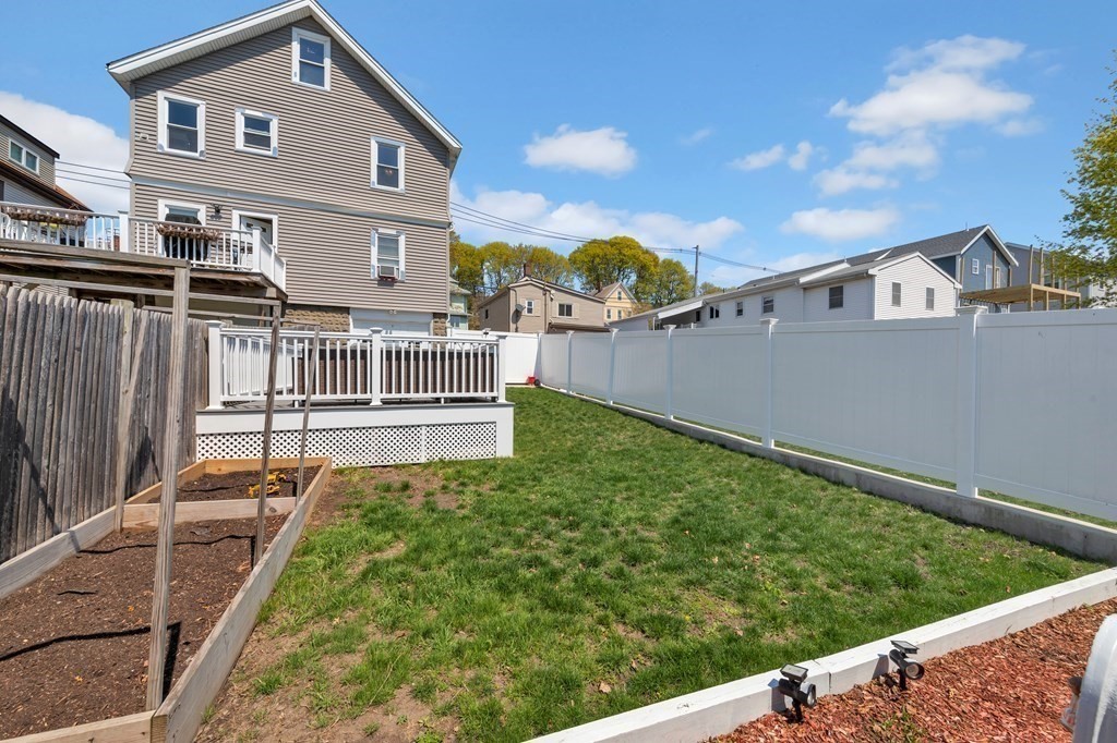 9-11 Locust Street, Unit 2 Winthrop, MA 02152 - Photo 36 of 41 a view of a house with a yard
