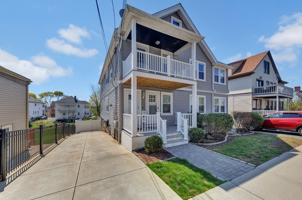 9-11 Locust Street, Unit 2 Winthrop, MA 02152 - Photo 40 of 41 a front view of a house with a garden and plants