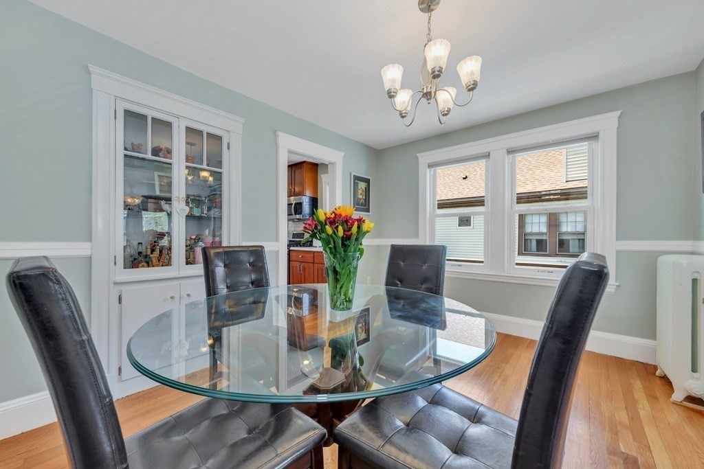 9-11 Locust Street, Unit 2 Winthrop, MA 02152 - Photo 9 of 41 a view of a dining room with furniture a chandelier and wooden floor