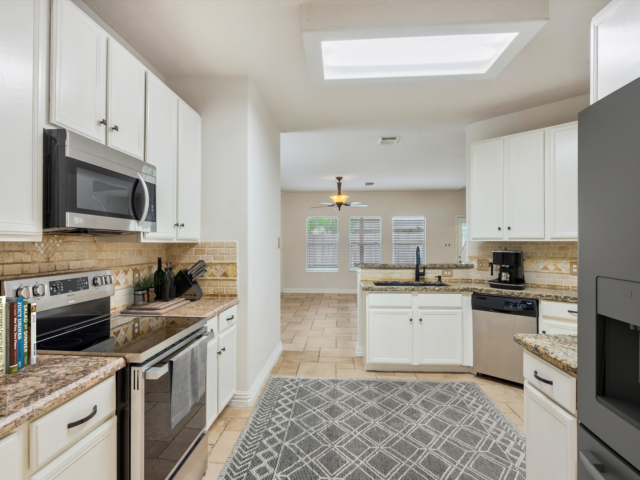 19422 Harvest Stream Way Houston, TX 77084 - Photo 11 of 41 Discover the elegance of a gourmet kitchen with gleaming granite countertops. AI-staged design to help you envision your dream kitchen.