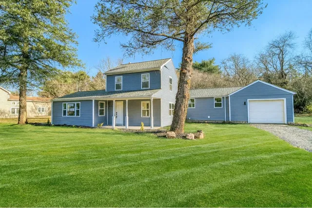 a front view of house with yard and trees