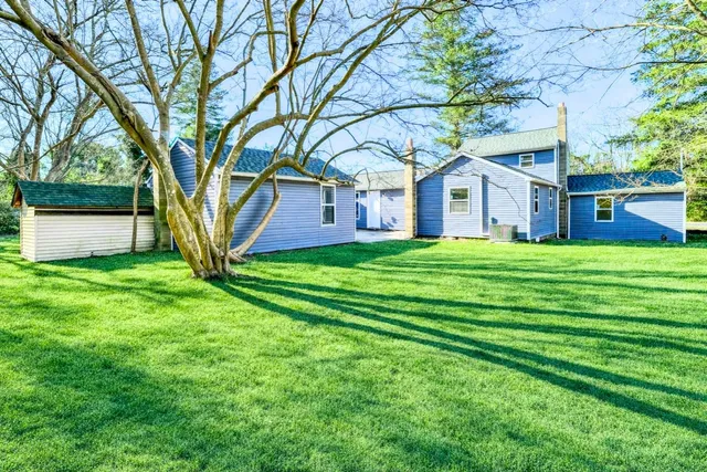 a house view with a sitting space and garden