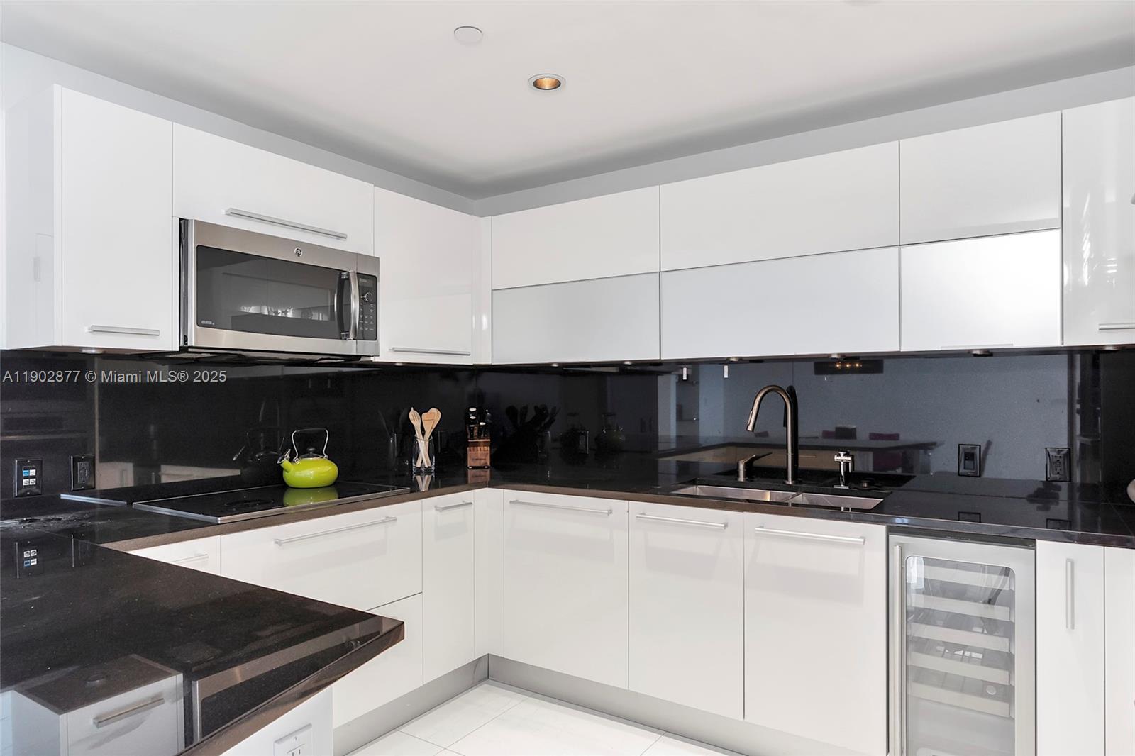 17121 Collins Avenue, Unit 2906 Sunny Isles Beach, FL 33160 - Photo 11 of 42 a kitchen with a sink and cabinets