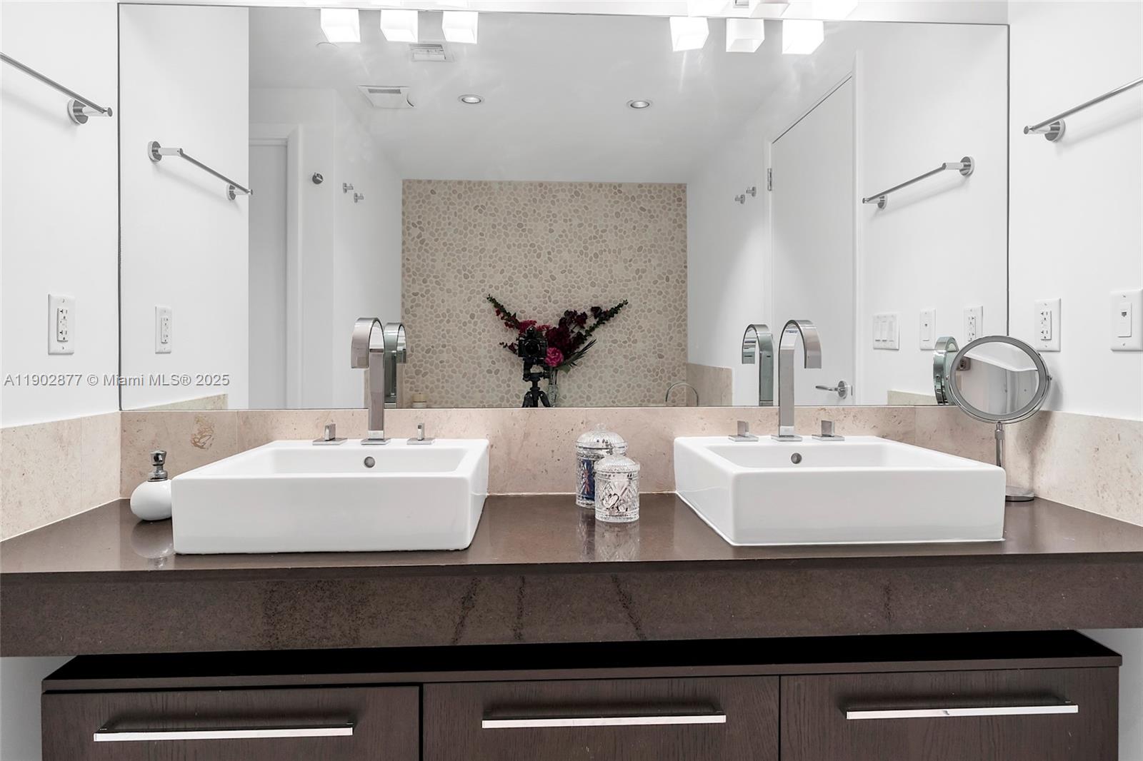 17121 Collins Avenue, Unit 2906 Sunny Isles Beach, FL 33160 - Photo 23 of 42 a bathroom with a sink and a mirror