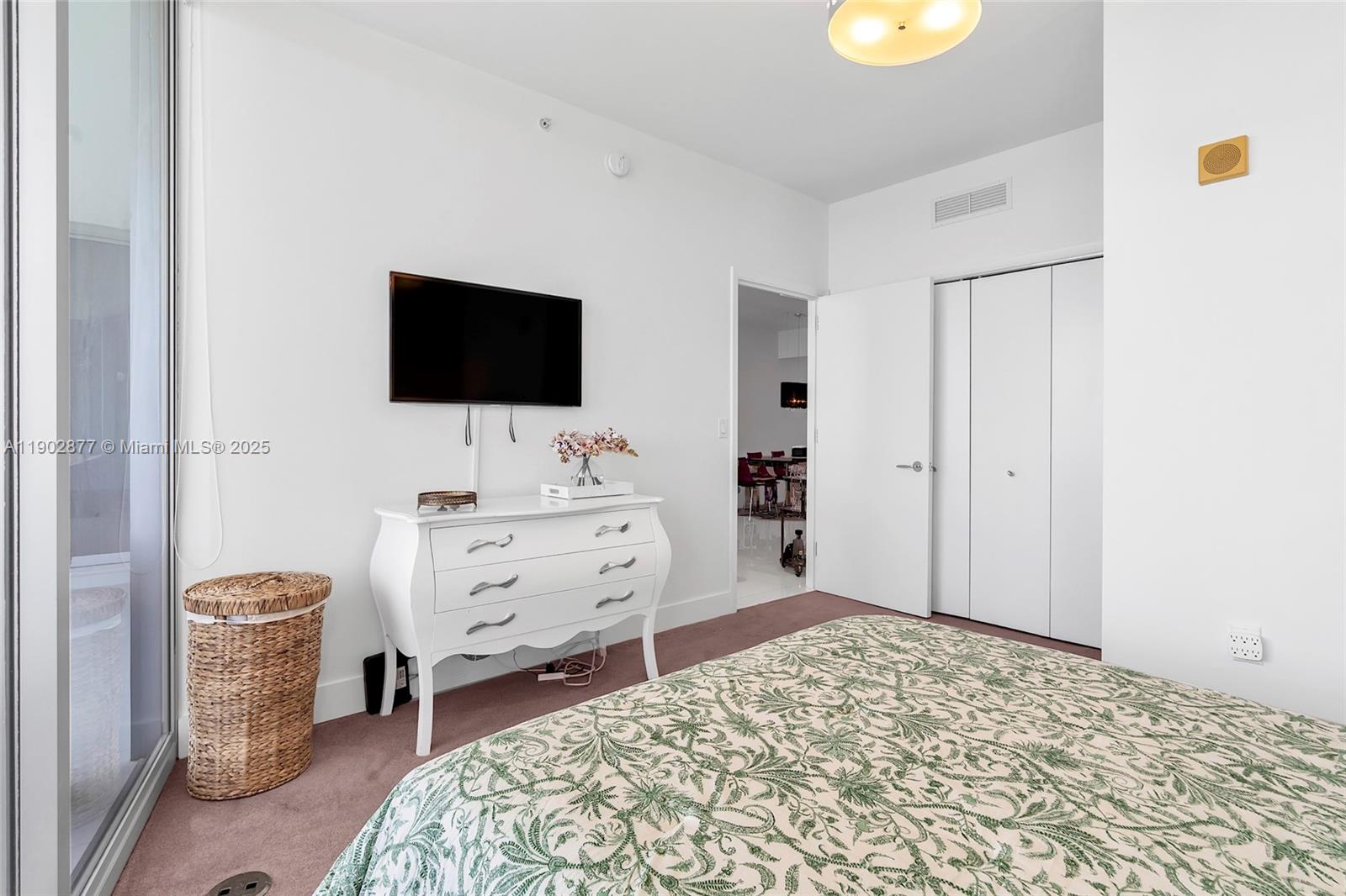 17121 Collins Avenue, Unit 2906 Sunny Isles Beach, FL 33160 - Photo 28 of 42 a bedroom with a bed and a flat screen tv