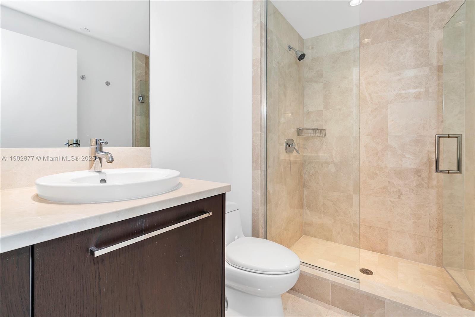 17121 Collins Avenue, Unit 2906 Sunny Isles Beach, FL 33160 - Photo 32 of 42 a bathroom with a sink toilet and shower