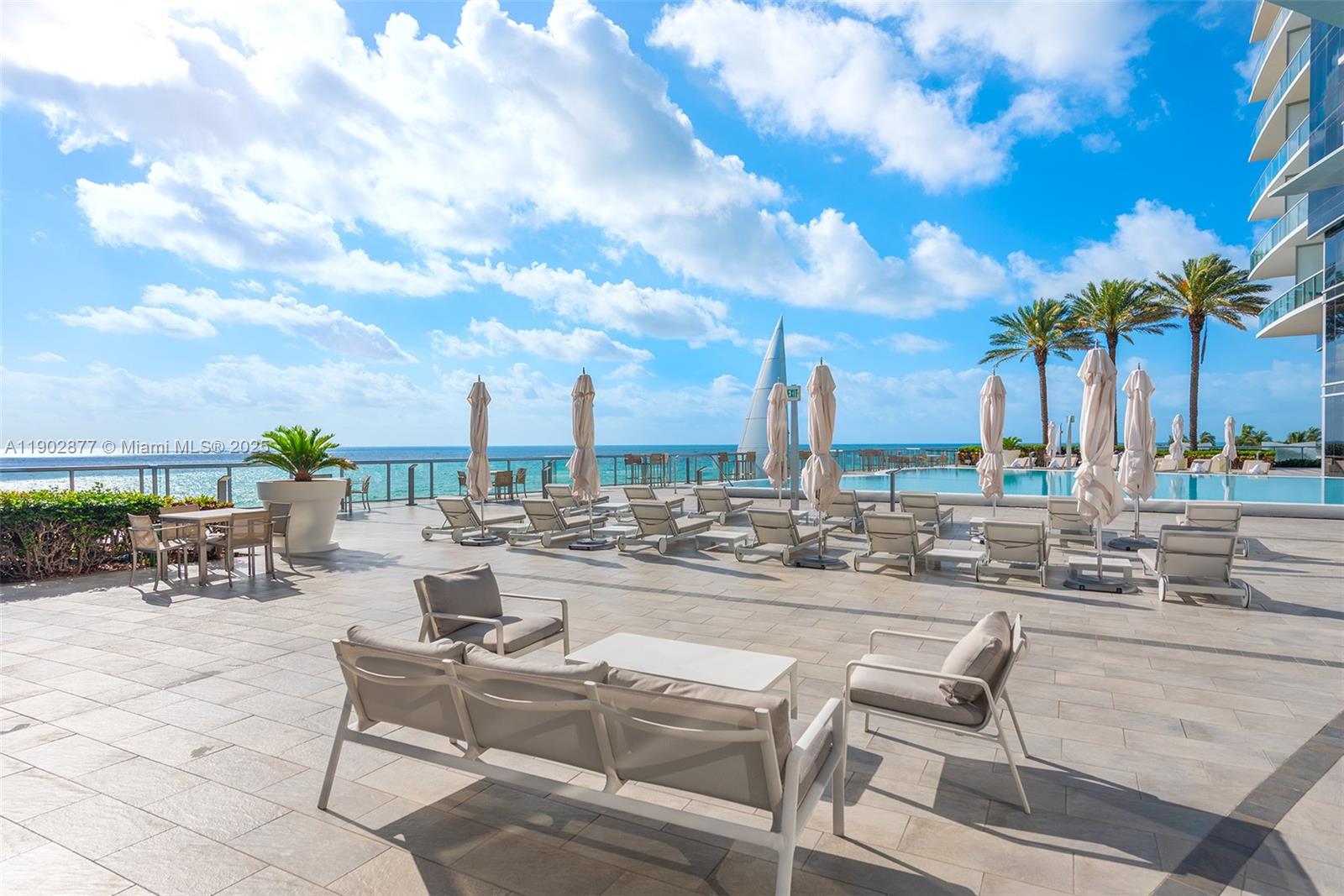 17121 Collins Avenue, Unit 2906 Sunny Isles Beach, FL 33160 - Photo 36 of 42 a view of outdoor space with seating area and barbeque oven