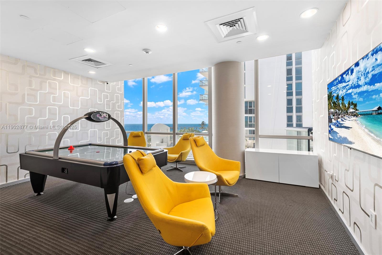 17121 Collins Avenue, Unit 2906 Sunny Isles Beach, FL 33160 - Photo 42 of 42 a living room with furniture and a flat screen tv