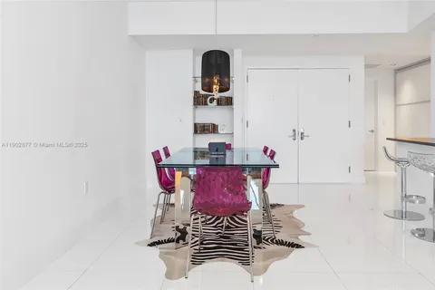 a view of a room with a table and chairs