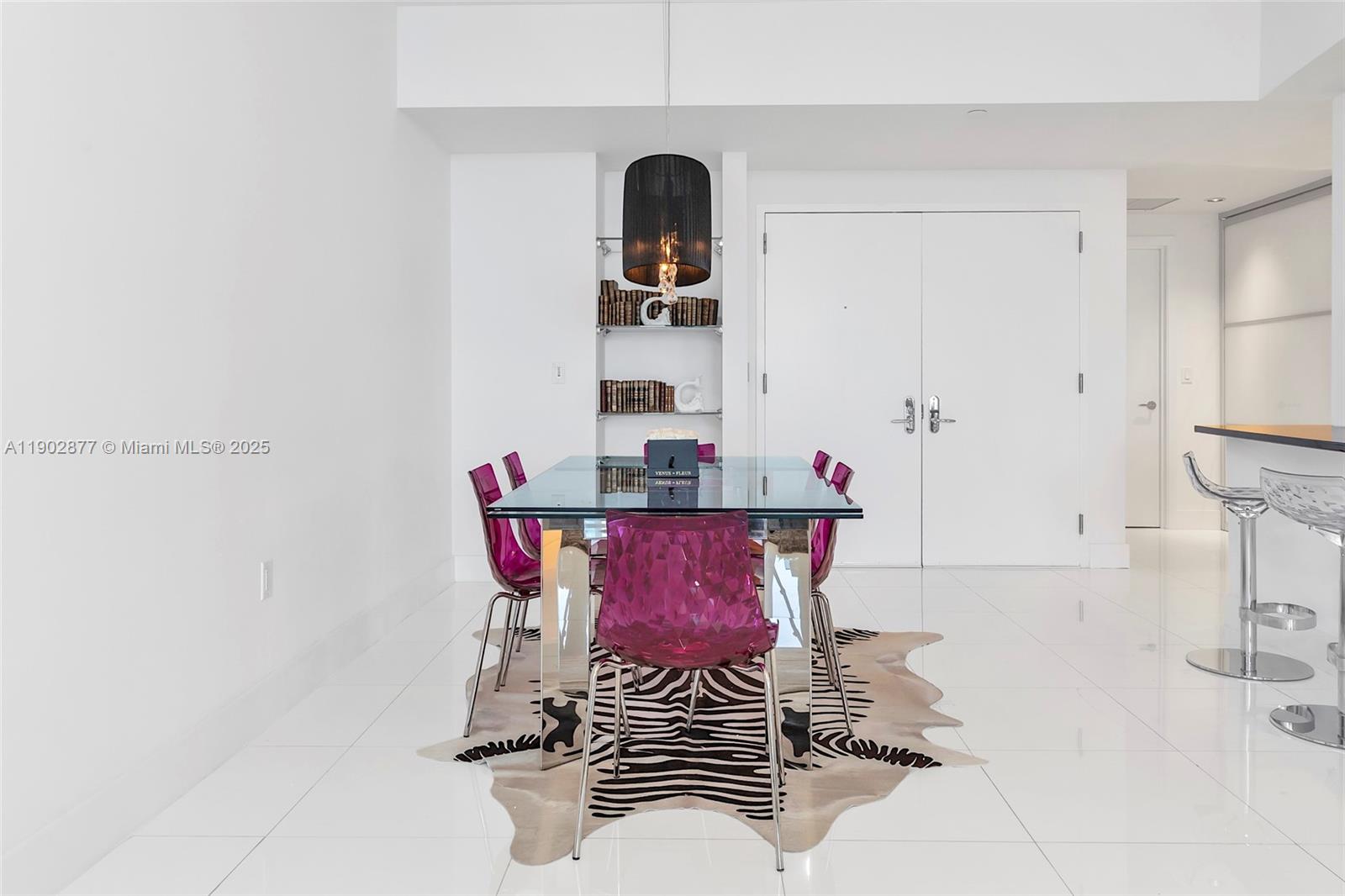 17121 Collins Avenue, Unit 2906 Sunny Isles Beach, FL 33160 - Photo 9 of 42 a view of a room with a table and chairs