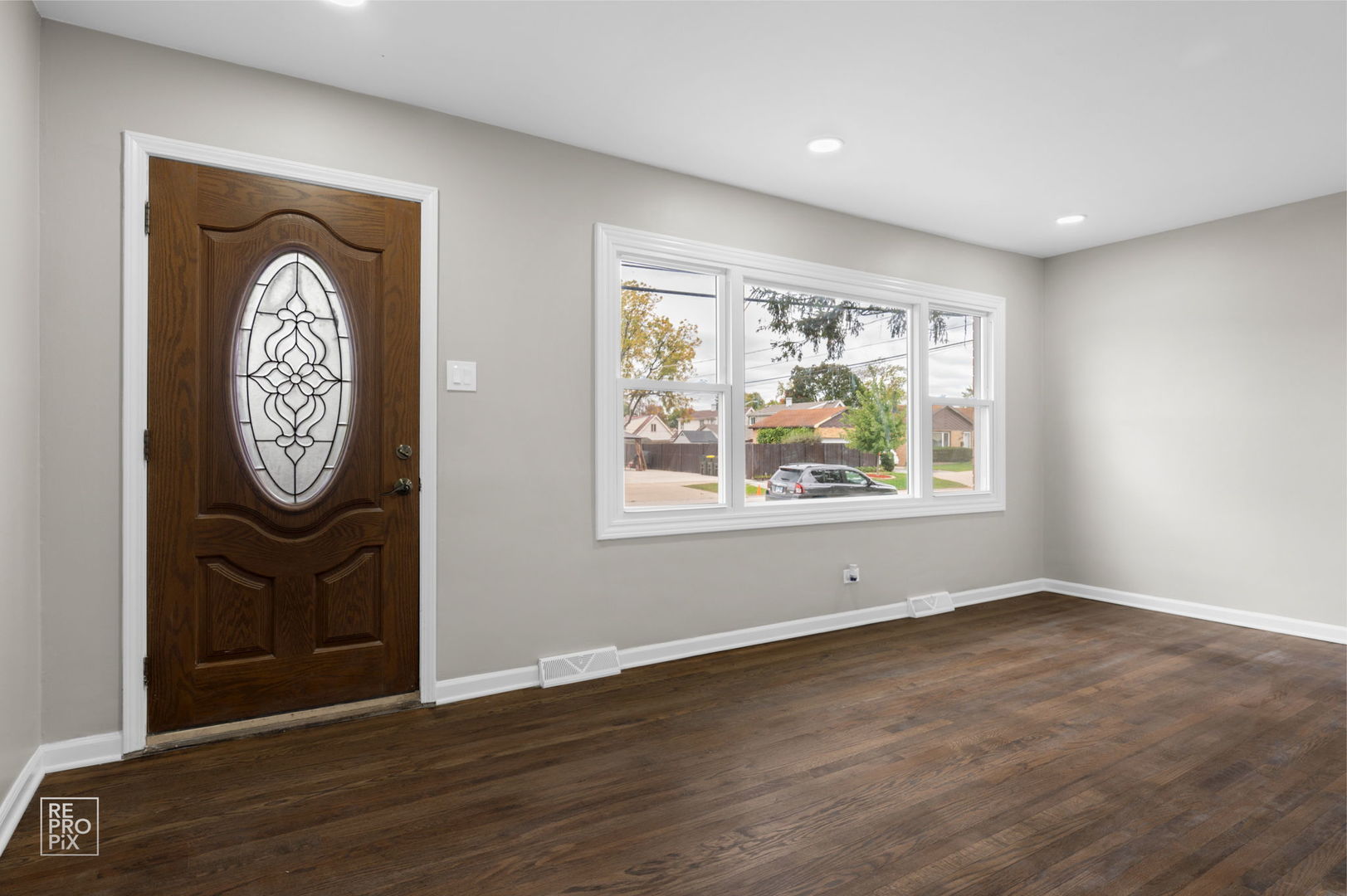 10854 Lyman Avenue Chicago Ridge, IL 60415 - Photo 2 of 10 an empty room with wooden floor and a window
