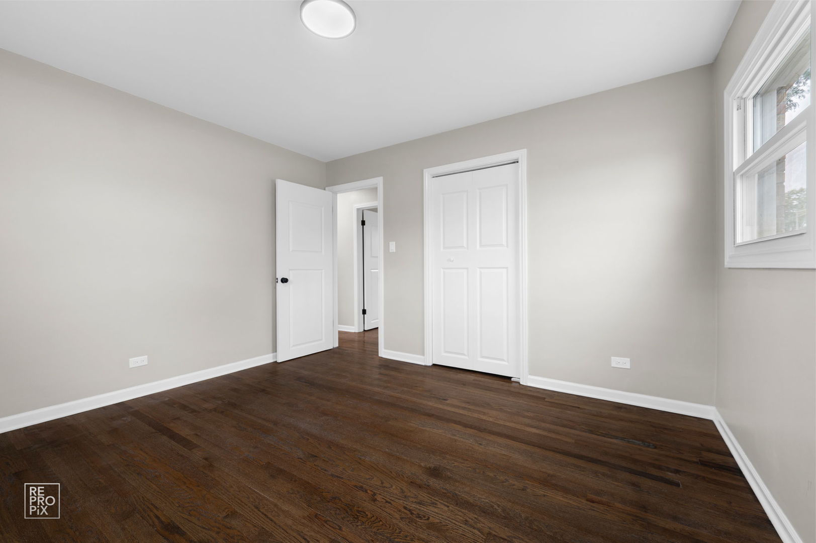 10854 Lyman Avenue Chicago Ridge, IL 60415 - Photo 9 of 10 a view of an empty room with wooden floor and a window