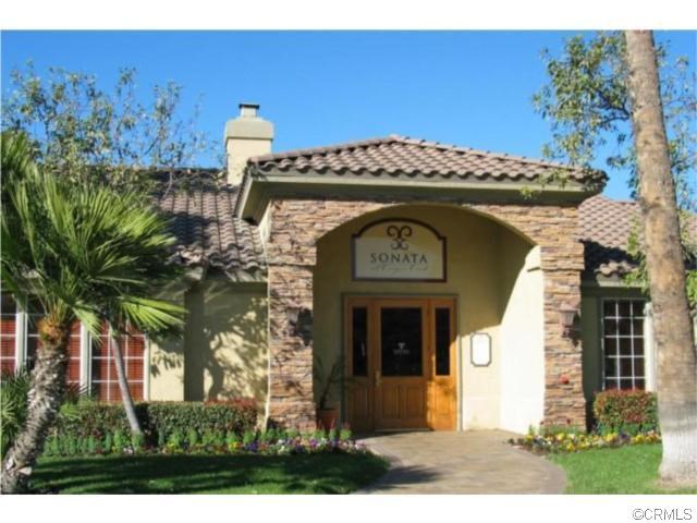 a front view of a house with plants
