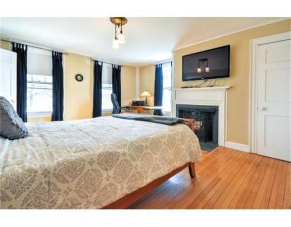 117 South Main Street Middleboro, MA 02346 - Photo 16 of 30 a spacious bedroom with a bed and a flat screen tv