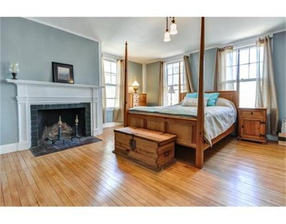 117 South Main Street Middleboro, MA 02346 - Photo 17 of 30 a spacious bedroom with a bed and a fireplace